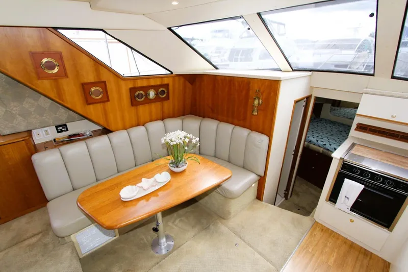 Slide: The Image of Interior of 1998 Silverton 372 Motor Yacht with dining area and kitchen. - 7