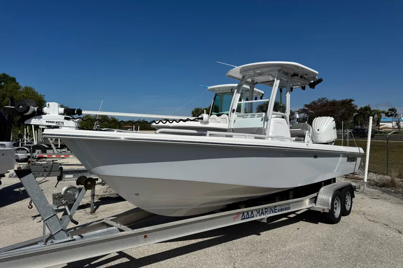 The Image of 2024 Everglades 243 Center Console boat on trailer under clear blue sky. - 1