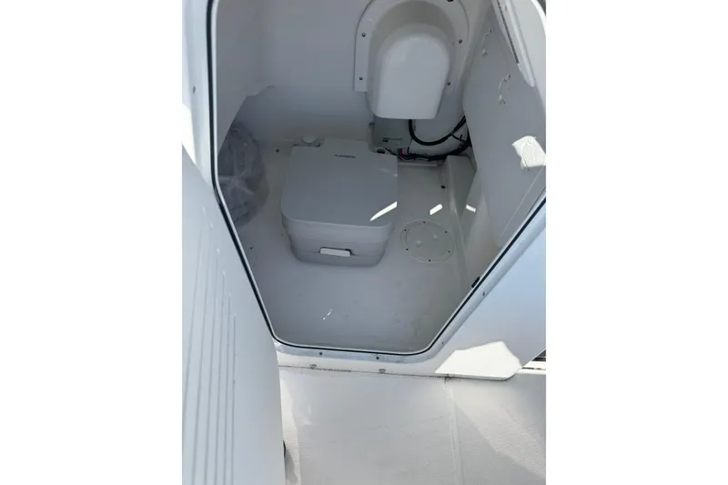 Slide: The Image of 2024 Everglades 243 Center Console interior with compact marine toilet. - 11