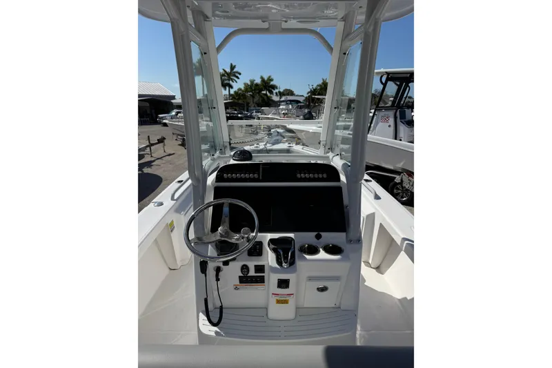 Slide: The Image of 2024 Everglades 243 Center Console boat interior with steering wheel and control panel. - 4