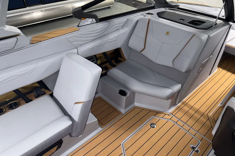 Slide: The Image of 2026 Nautique Super Air Nautique G23 interior with luxurious seating and teak flooring. - 11