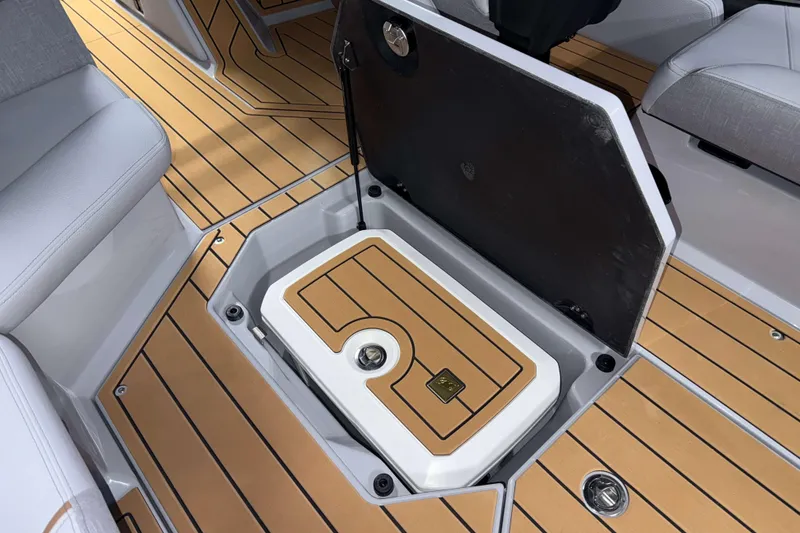 Slide: The Image of 2026 Nautique Super Air Nautique G23 storage compartment with teak-style flooring. - 13