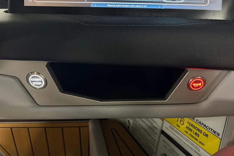 Slide: The Image of 2026 Nautique Super Air Nautique G23 dashboard with start-stop button and warning indicator. - 19