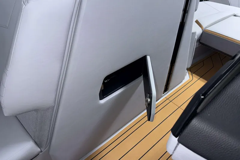 Slide: The Image of 2026 Nautique Super Air Nautique G23 interior with open storage compartment. - 22