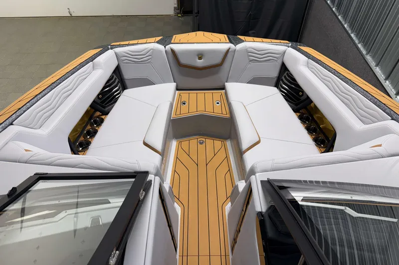 Slide: The Image of 2026 Nautique Super Air Nautique G23 boat interior with luxurious seating and wood accents. - 31