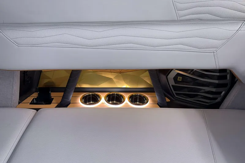 Slide: The Image of 2026 Nautique Super Air Nautique G23 interior with illuminated cup holders and luxurious seating. - 37