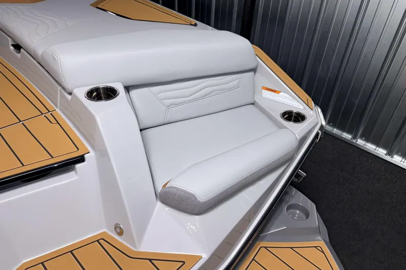 Slide: The Image of 2026 Nautique Super Air Nautique G23 boat interior with cushioned seating and cup holders. - 4