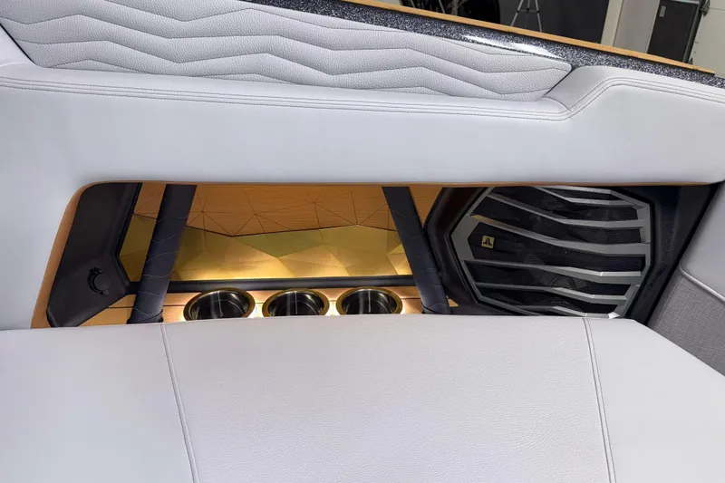 Slide: The Image of 2026 Nautique Super Air Nautique G23 interior with speaker and cup holders. - 40