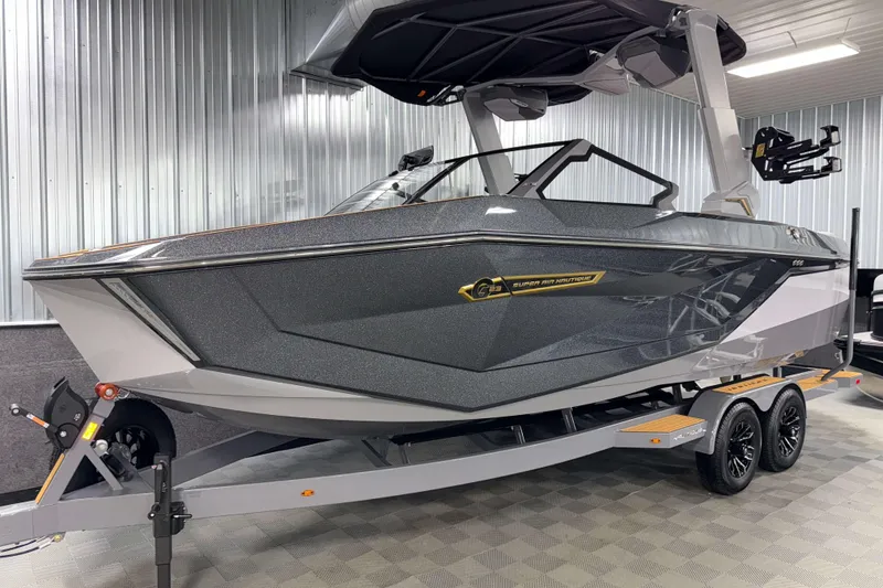 Slide: The Image of 2026 Nautique Super Air Nautique G23 boat in showroom, sleek design, on trailer. - 48