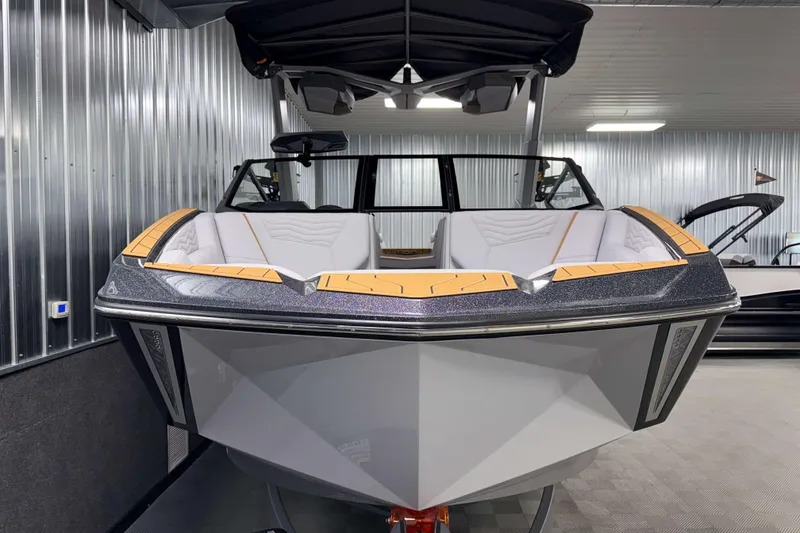 Slide: The Image of 2026 Nautique Super Air Nautique G23 boat in a modern indoor showroom. - 49