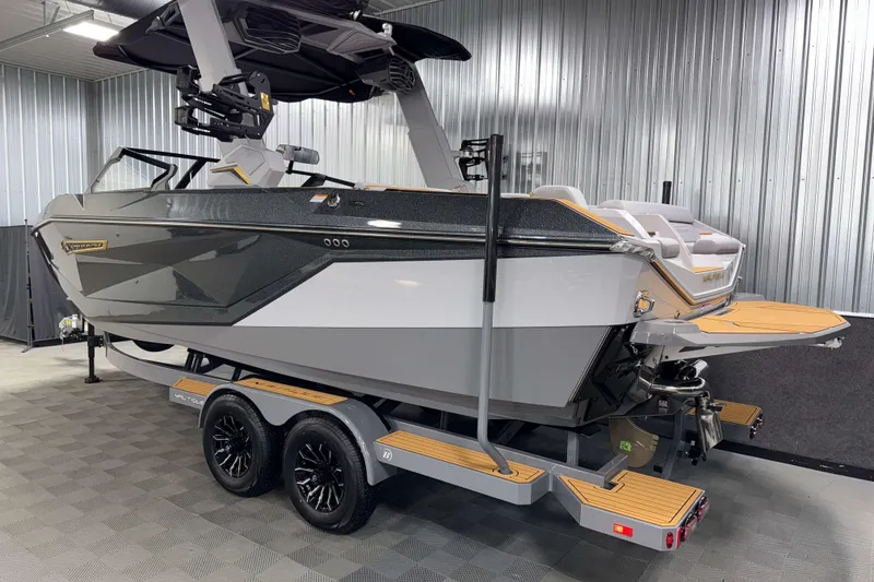Slide: The Image of 2026 Nautique Super Air Nautique G23 boat on trailer in a garage setting. - 51
