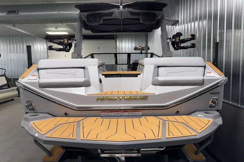 Slide: The Image of 2026 Nautique Super Air Nautique G23 boat, rear view in a metallic garage. - 52