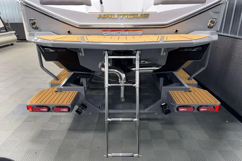 Slide: The Image of 2026 Nautique Super Air Nautique G23 boat rear view with swim platform and ladder. - 53
