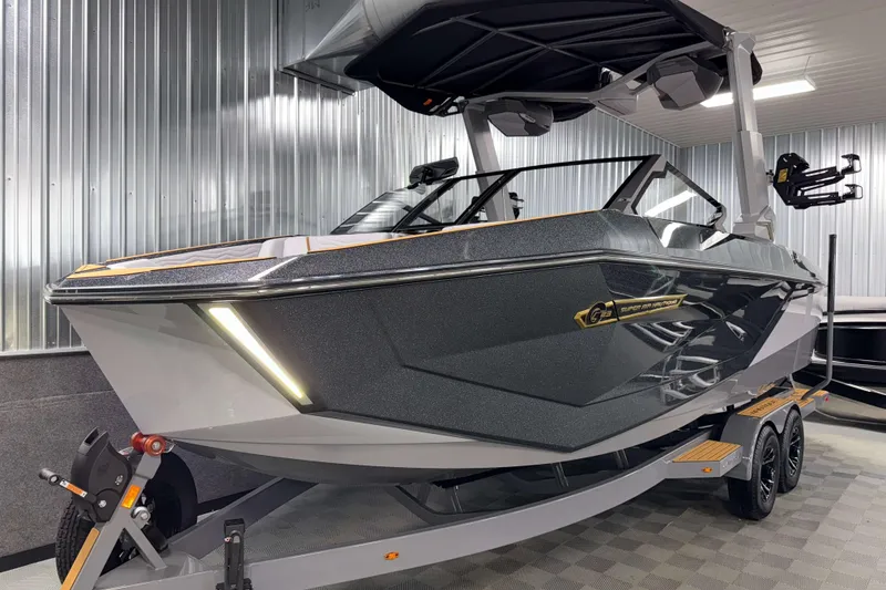 Slide: The Image of 2026 Nautique Super Air Nautique G23 boat in showroom, sleek design, metallic finish. - 57