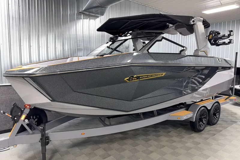 Slide: The Image of 2026 Nautique Super Air Nautique G23 boat in showroom, sleek design, on trailer. - 59