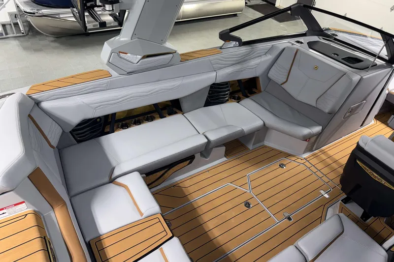 Slide: The Image of 2026 Nautique Super Air Nautique G23 interior with luxurious seating and teak flooring. - 6