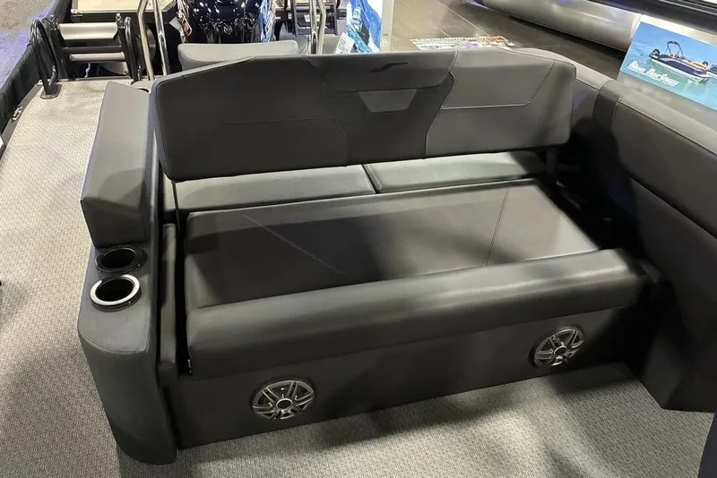 Slide: The Image of 2026 Evotti 523CS boat interior with black seating, cup holders, and integrated speakers. - 5