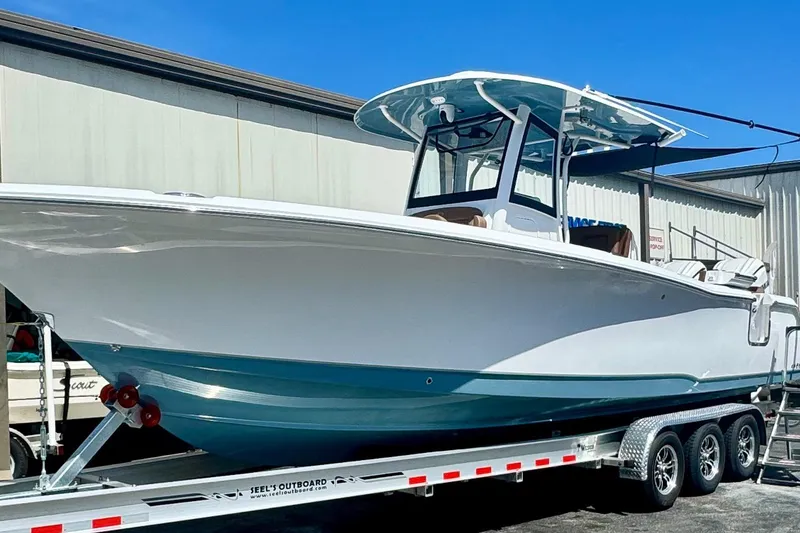 The Image of 2025 Sea Hunt Ultra 305 SE boat on trailer, displayed outdoors. - 0