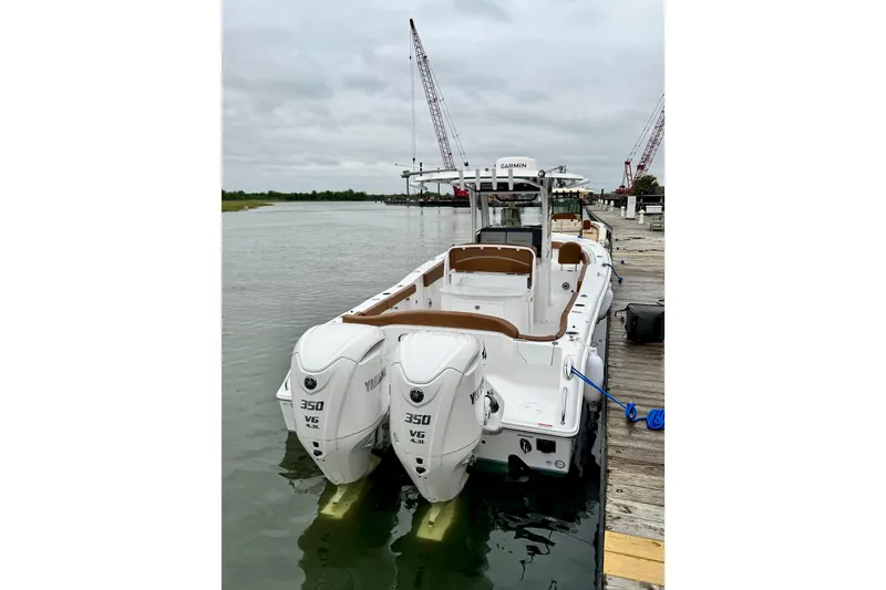 Slide: The Image of 2025 Sea Hunt Ultra 305 SE boat docked with twin Yamaha 350 engines. - 3