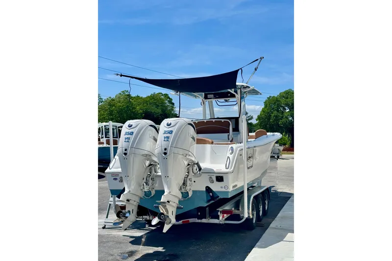 Slide: The Image of 2025 Sea Hunt Ultra 305 SE boat with dual Yamaha 350 engines on a trailer. - 5