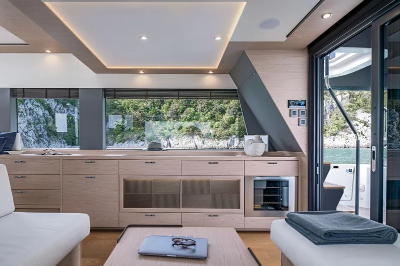 Slide: The Image of Manufacturer Provided Image: Luxurious interior of 2025 Beneteau Grand Trawler 63 with modern design and scenic window view. - 3