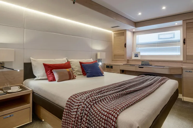 Slide: The Image of Manufacturer Provided Image: Luxurious bedroom interior of 2025 Beneteau Grand Trawler 63 with modern decor and cozy bedding. - 4