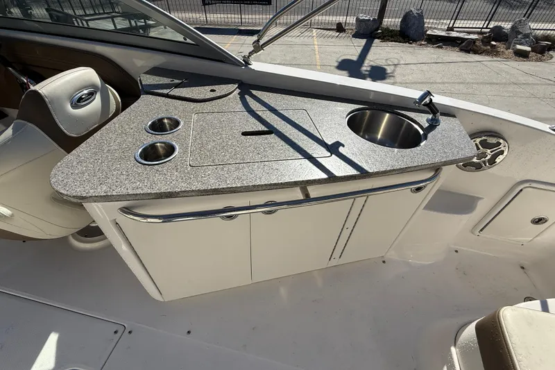 Slide: The Image of 2014 Chaparral 264 Sunesta boat interior with kitchenette and sink. - 14