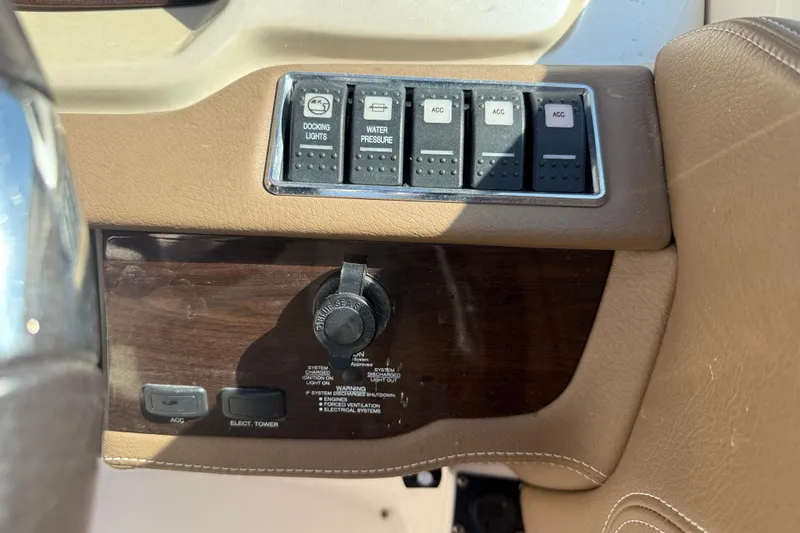 Slide: The Image of Control panel of a 2014 Chaparral 264 Sunesta boat with switches and ignition. - 17