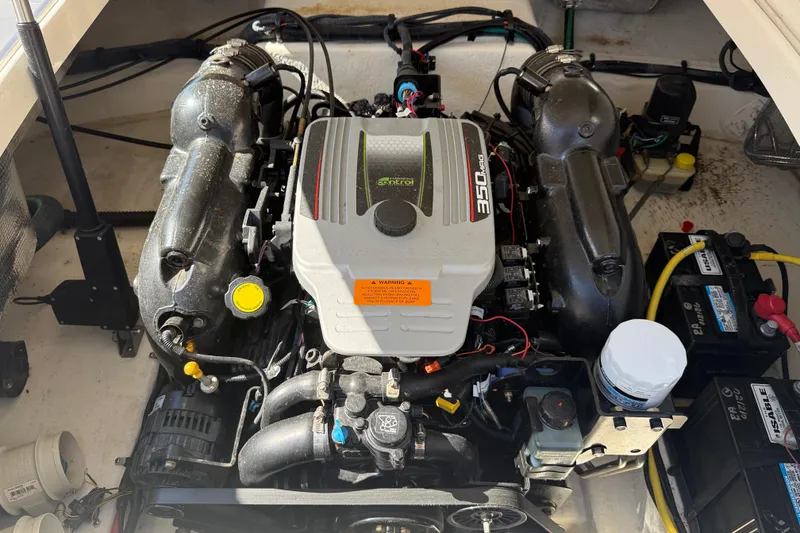 Slide: The Image of Engine compartment of a 2014 Chaparral 264 Sunesta boat, featuring a 350 MAG engine. - 21