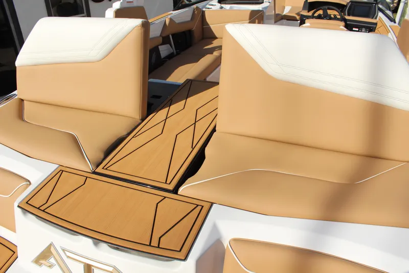 Slide: The Image of 2026 ATX Surf Boats 22 Type-S interior with tan and white seating, stylish deck design. - 11