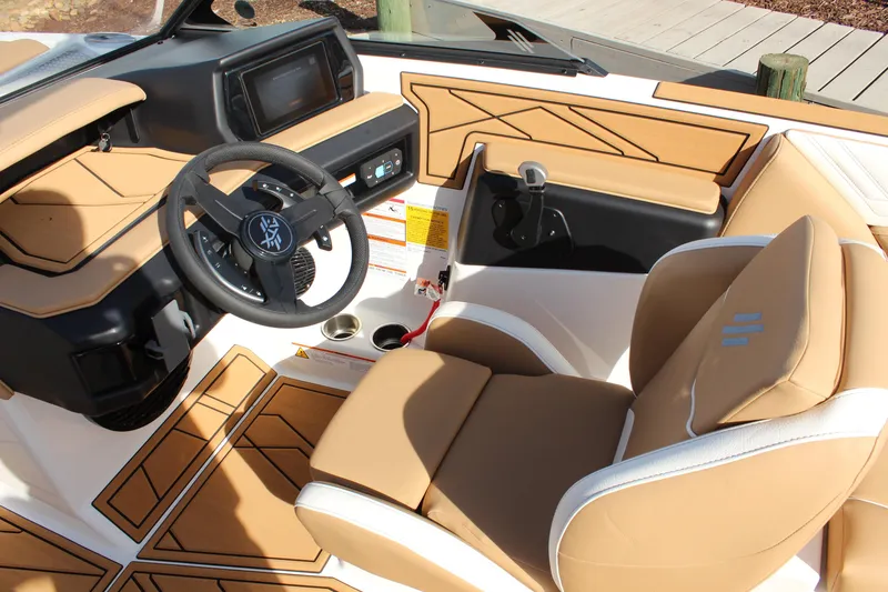 Slide: The Image of 2026 ATX Surf Boats 22 Type-S interior with tan upholstery and modern dashboard. - 19