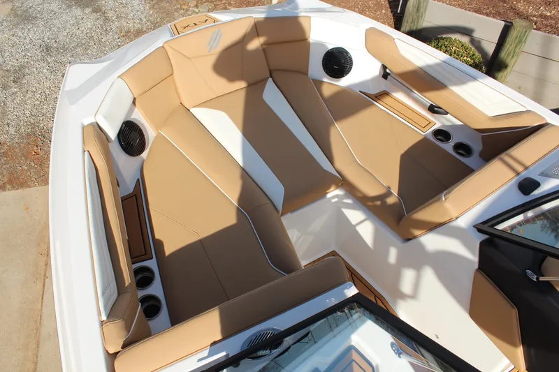 Slide: The Image of 2026 ATX Surf Boats 22 Type-S interior with tan and white seating, cup holders, and speakers. - 2
