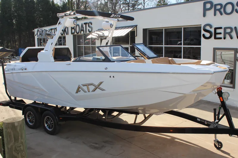 Slide: The Image of 2026 ATX Surf Boats 22 Type-S on trailer outside dealership. - 7