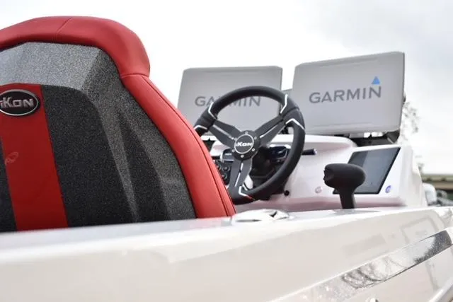 Slide: The Image of 2024 iKon LX21 boat interior with Garmin navigation displays and red-accented seating. - 2