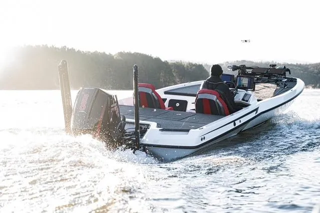 Slide: The Image of 2024 iKon LX21 boat cruising on a lake with two passengers, surrounded by scenic nature. - 3