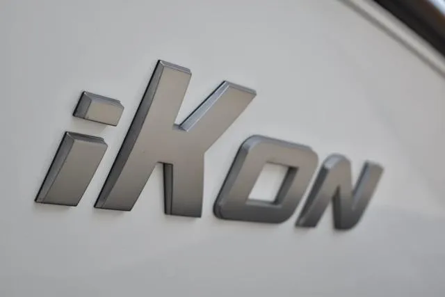 Slide: The Image of 2024 iKon LX21 logo on vehicle exterior, sleek metallic design. - 6