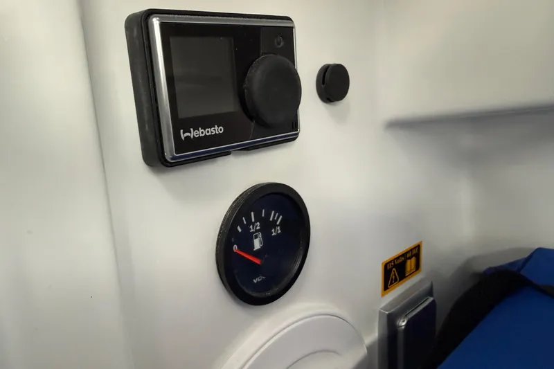 Slide: The Image of Control panel and fuel gauge in 2024 Jeanneau NC 695 Sport boat interior. - 29