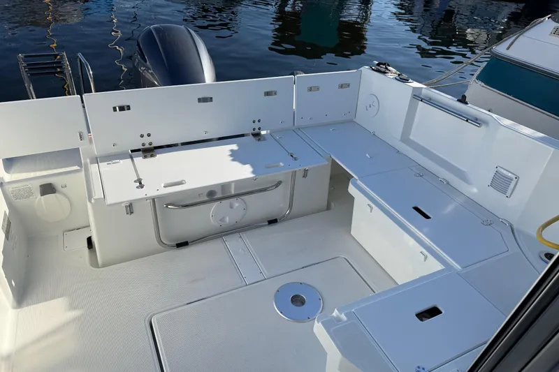 Slide: The Image of 2024 Jeanneau NC 695 Sport boat interior with seating and storage compartments. - 31