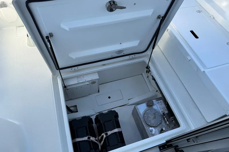 Slide: The Image of 2024 Jeanneau NC 695 Sport storage compartment with battery and equipment. - 34