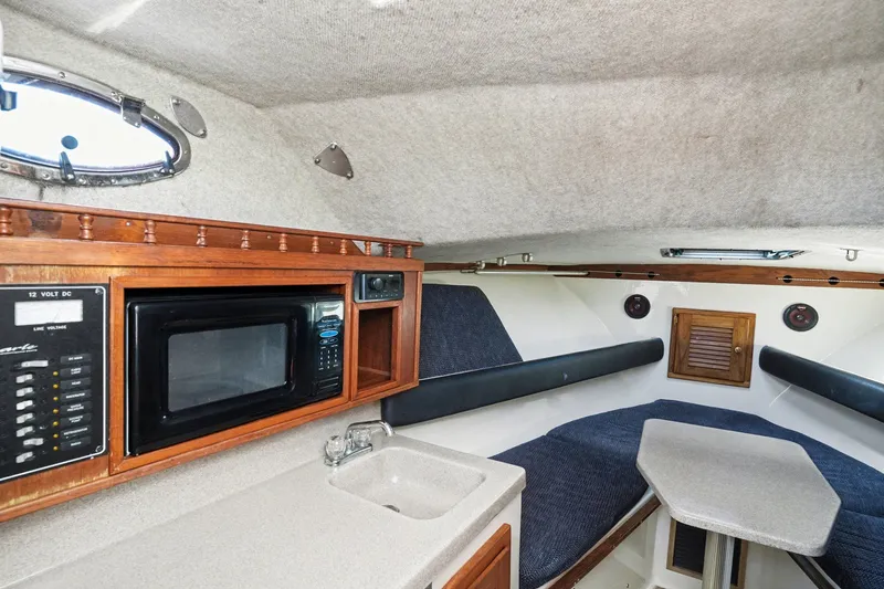 Slide: The Image of Interior of 2002 Albemarle 28 Express with kitchenette and seating area. - 12