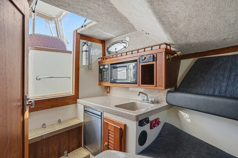 Slide: The Image of Interior of 2002 Albemarle 28 Express with kitchenette and seating area. - 14