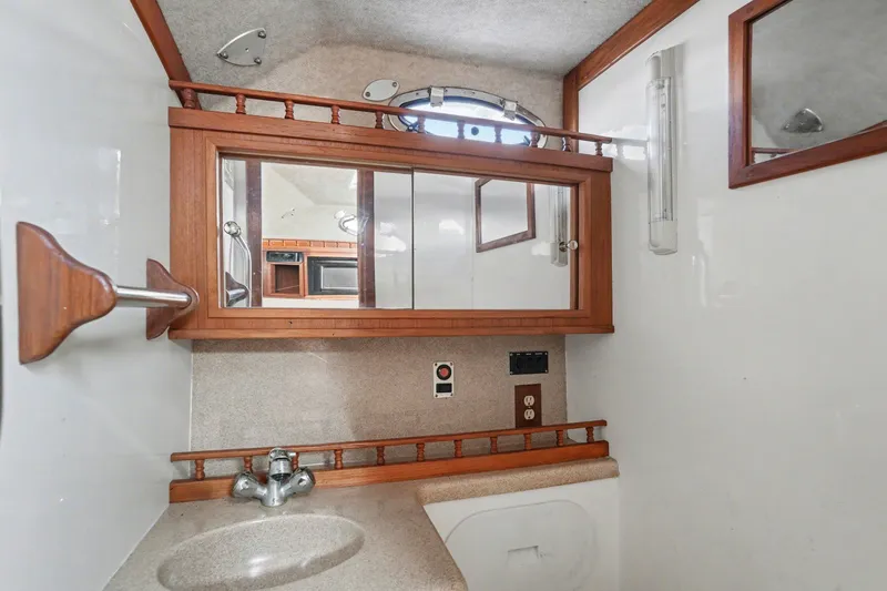 Slide: The Image of Interior of 2002 Albemarle 28 Express with mirror and sink. - 15