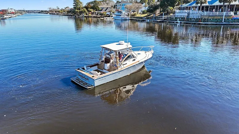 Slide: The Image of 2002 Albemarle 28 Express boat on a calm river. - 23