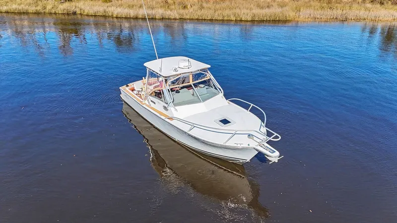 Slide: The Image of 2002 Albemarle 28 Express boat on calm water. - 25