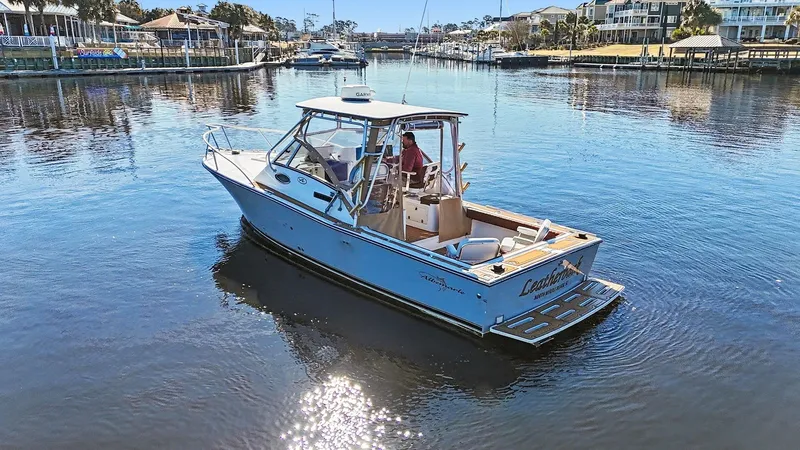 Slide: The Image of Albemarle 28 Express 2002 boat on calm harbor waters. - 26