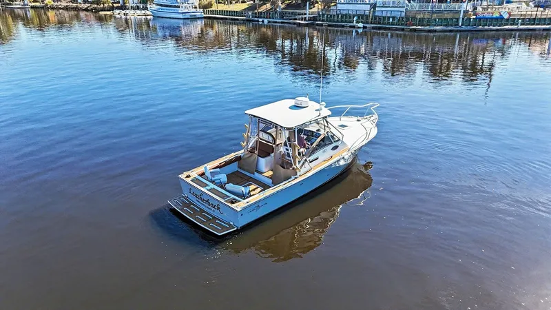 Slide: The Image of 2002 Albemarle 28 Express boat on calm water. - 27