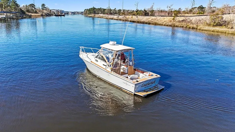 Slide: The Image of Albemarle 28 Express 2002 on a calm river. - 29
