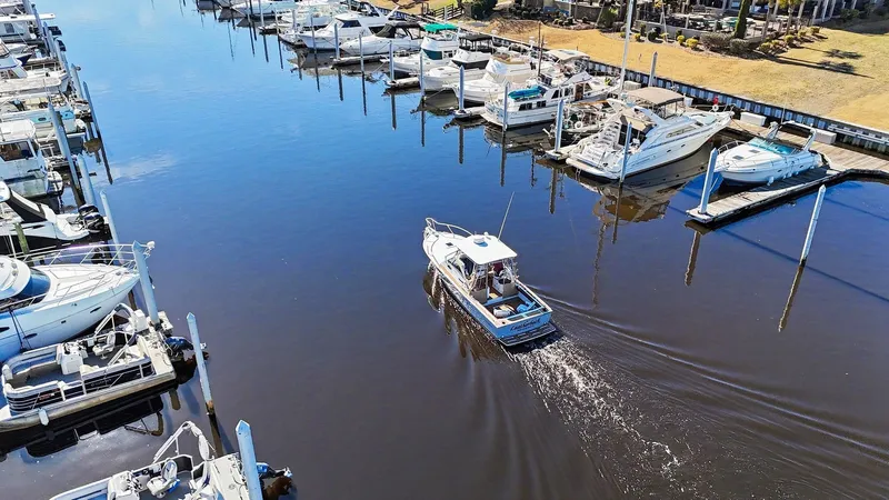 Slide: The Image of 2002 Albemarle 28 Express in marina, surrounded by boats. - 30