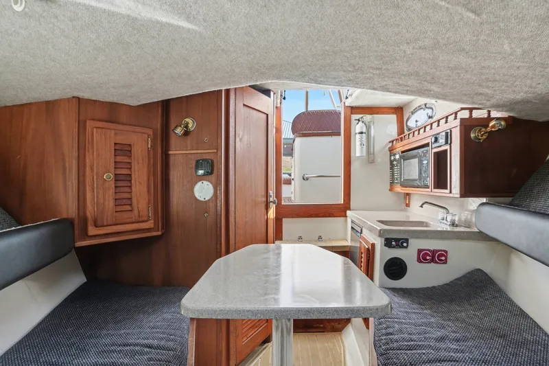 Slide: The Image of Interior of 2002 Albemarle 28 Express with kitchenette and seating area. - 5