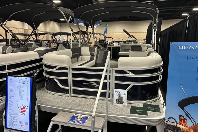 The Image of 2025 Bennington S L-Bench 20 SL pontoon boat displayed at an indoor exhibition. - 0